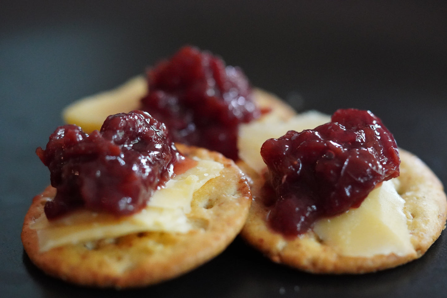 Sour Cherry Vieux Carre on top of cheese and crackers