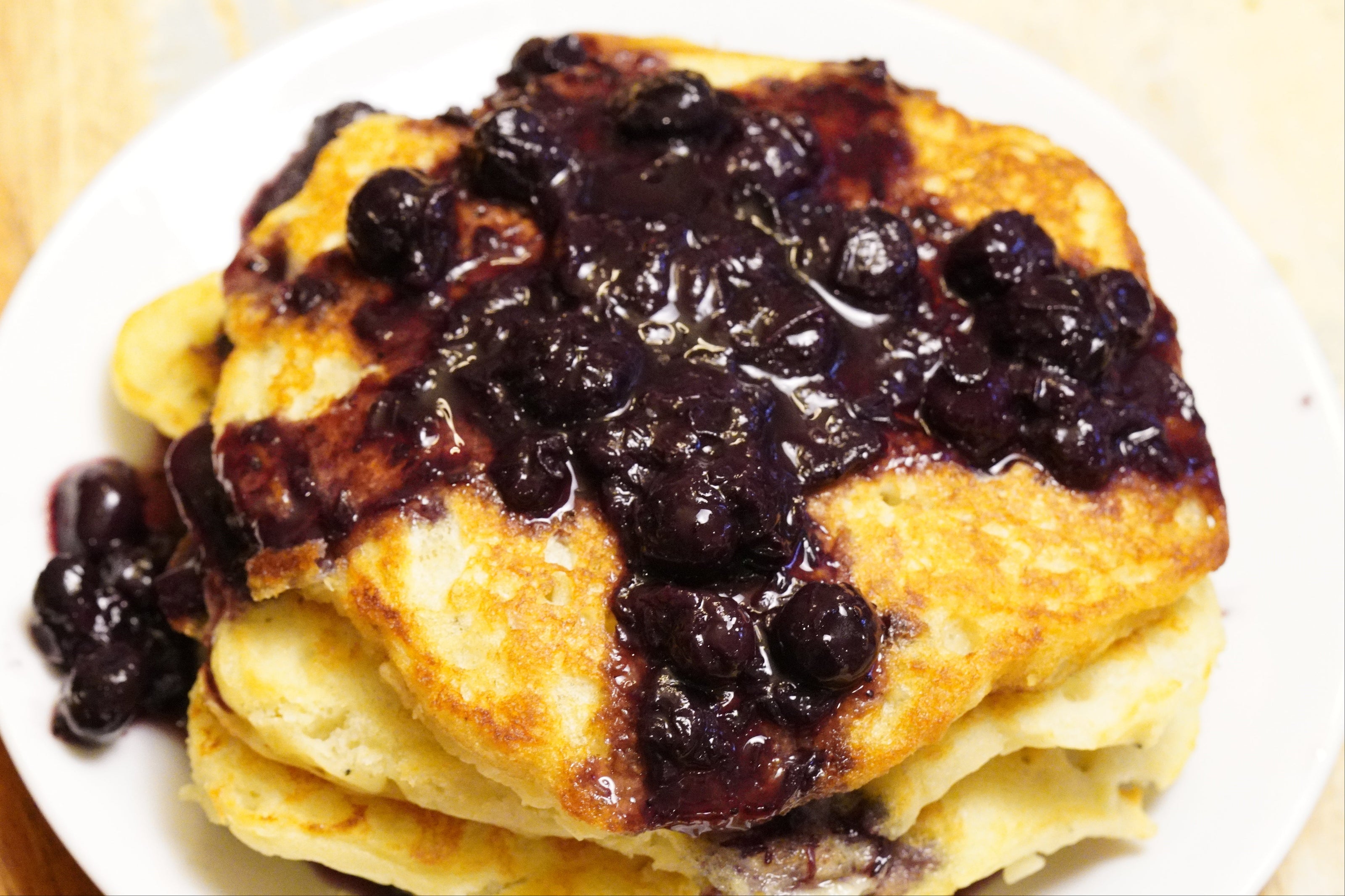 Stack of pancakes with blueberry sunrise on top