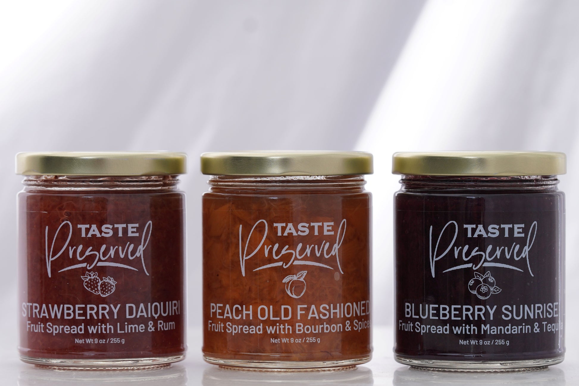 Front jar view of Strawberry Daiquiri, Peach Old Fashioned and Blueberry Sunrise